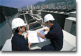 Staff checking the air-conditioning system at the Cheung Sha Wan Government Office Building.