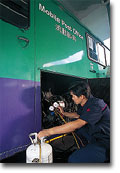 Staff checking air-conditioning unit on a mobile post office of the Hongkong Post.